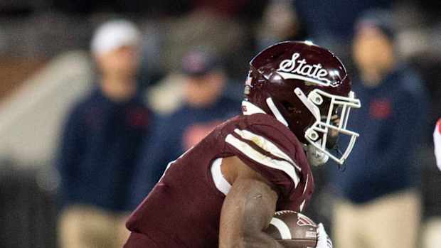 Mississippi State's Marcus Banks (1) gets taken down by LB Jeremiah Jean-Baptiste during a punt return in second half of the Egg Bowl at Davis Wade Stadium in Starkville, Miss.